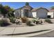 Attractive single-story home with low maintenance landscaping and two-car garage at 4061 W Tonopah Dr, Glendale, AZ 85308