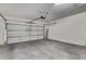 Spacious two-car garage featuring concrete flooring, overhead door, and ample storage space at 4061 W Tonopah Dr, Glendale, AZ 85308