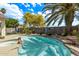 Inviting backyard pool and spa surrounded by mature palm trees and desert landscaping, offering a serene retreat at 4061 W Tonopah Dr, Glendale, AZ 85308