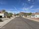 Wide street view, capturing the neighborhood's serene environment and desert landscaping at 4061 W Tonopah Dr, Glendale, AZ 85308