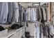 Organized walk-in closet with hanging rods, shelving, and storage drawers for optimal space utilization at 4061 W Tonopah Dr, Glendale, AZ 85308