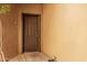 Close up of a solid, 6-panel exterior door with brown paint and silver hardware and a small overhang at 4644 N 22Nd St # 1137, Phoenix, AZ 85016