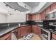 Well-lit kitchen features stainless appliances, dark countertops, and wood cabinetry at 4644 N 22Nd St # 1137, Phoenix, AZ 85016