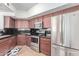 Kitchen featuring updated stainless steel appliances, dark counter tops, and wood cabinets at 4644 N 22Nd St # 1137, Phoenix, AZ 85016