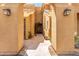 A landscaped walkway leading to a condominium unit with stone, plants, and decorative lights on the walls at 4644 N 22Nd St # 1137, Phoenix, AZ 85016