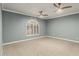 Empty bedroom features a ceiling fan, large window with shutters, and neutral decor at 4747 N 84Th Way, Scottsdale, AZ 85251