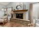 Close up of a cozy stone fireplace with mantel in a well-lit living room at 4747 N 84Th Way, Scottsdale, AZ 85251