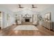 Bright living room with vaulted ceiling, cozy fireplace, and wood-look flooring at 4747 N 84Th Way, Scottsdale, AZ 85251