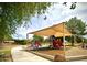 The playground features a colorful array of slides and climbing structures under a sunshade at 4747 N 84Th Way, Scottsdale, AZ 85251
