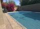 Private pool with protective safety net in a fenced backyard oasis at 4747 N 84Th Way, Scottsdale, AZ 85251