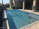 Backyard pool covered with a blue safety net and patio surround with an attached porch at 4747 N 84Th Way, Scottsdale, AZ 85251