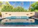 Inviting backyard pool with a tiled wall and waterfall feature, surrounded by lush landscaping at 4747 N 84Th Way, Scottsdale, AZ 85251