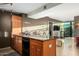 Well-equipped kitchen with dark countertops, wooden cabinetry, and modern appliances, plus breakfast bar at 4808 N 24Th St # 527, Phoenix, AZ 85016