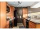 Modern kitchen with granite countertops, stainless steel appliances, wood cabinets, and neutral tones at 4808 N 24Th St # 527, Phoenix, AZ 85016