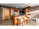 Compact kitchen featuring granite countertops, wooden cabinets, and modern appliances, plus seating at 4808 N 24Th St # 527, Phoenix, AZ 85016