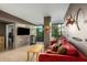 Inviting living room with modern furnishings, plush red sofa, neutral tones, and large windows at 4808 N 24Th St # 527, Phoenix, AZ 85016