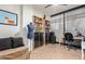 Bright home office with a large bookcase, writing desk, neutral walls, and tile flooring throughout at 4808 N 24Th St # 527, Phoenix, AZ 85016