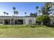 A beautiful backyard and lush green landscaping with palm trees near the home at 562 S Palo Verde Way, Mesa, AZ 85208