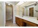 Bright bathroom featuring a sink with under-cabinet storage and a separate toilet room at 562 S Palo Verde Way, Mesa, AZ 85208