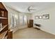 This room features carpeted floors, three windows, a ceiling fan and furniture at 562 S Palo Verde Way, Mesa, AZ 85208