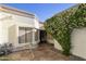 Charming home exterior with decorative rock, plants and a table with chairs at 562 S Palo Verde Way, Mesa, AZ 85208