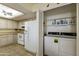 Bright, modern kitchen with white appliances and spacious countertops, adjacent to laundry at 562 S Palo Verde Way, Mesa, AZ 85208
