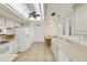 Well-lit kitchen with a ceiling fan, white appliances, plenty of counter space, and a dining nook at 562 S Palo Verde Way, Mesa, AZ 85208