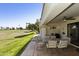 Relaxing covered patio with a dining set overlooking the lush green lawn at 562 S Palo Verde Way, Mesa, AZ 85208