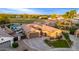 Aerial view of a single Gathering house, pool, and large lot with mature trees and grass at 5639 S Four Peaks Pl, Chandler, AZ 85249