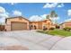 Southwest home with a three car garage and expansive driveway with palm trees at 5639 S Four Peaks Pl, Chandler, AZ 85249