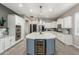 Spacious kitchen features a large center island, white cabinetry, and stainless steel appliances at 5639 S Four Peaks Pl, Chandler, AZ 85249