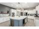Bright kitchen with center island featuring white countertops, cabinetry and stainless steel appliances at 5639 S Four Peaks Pl, Chandler, AZ 85249