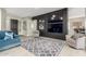 Stylishly furnished living room featuring a striking accent wall and comfortable seating at 5639 S Four Peaks Pl, Chandler, AZ 85249