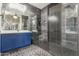 Modern main bathroom with a walk-in shower, stylish fixtures, and decorative tile flooring at 5639 S Four Peaks Pl, Chandler, AZ 85249