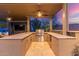 This outdoor kitchen features a grill, counter space, sink, and ceiling fans for comfort and convenience at 5639 S Four Peaks Pl, Chandler, AZ 85249