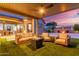 This outdoor patio has cushioned seating, a fire pit, and a view of the outdoor dining area at 5639 S Four Peaks Pl, Chandler, AZ 85249
