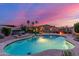 Backyard with a pool, spa, patio, fire pit, and mature trees under a colorful sunset sky at 5639 S Four Peaks Pl, Chandler, AZ 85249