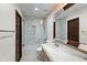Classic bathroom with marble vanity, mosaic tile shower and wood door at 5740 N Casa Blanca Dr, Paradise Valley, AZ 85253
