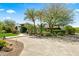 Circular driveway leading to a lush landscaped home with mature trees and lawn at 5740 N Casa Blanca Dr, Paradise Valley, AZ 85253