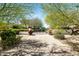 Gated driveway entrance to a home with desert landscaping and mature trees at 5740 N Casa Blanca Dr, Paradise Valley, AZ 85253