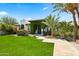 Lush lawn and greenery accent this home's exterior with a vine-covered entrance at 5740 N Casa Blanca Dr, Paradise Valley, AZ 85253