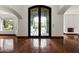Elegant foyer with dark wood floors and an ornate wrought iron front door at 5740 N Casa Blanca Dr, Paradise Valley, AZ 85253