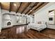 Expansive main bedroom with beamed ceilings, a cozy fireplace, and ample natural light from large windows at 5740 N Casa Blanca Dr, Paradise Valley, AZ 85253