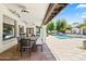 Covered patio with an outdoor dining area and views of the pool at 5740 N Casa Blanca Dr, Paradise Valley, AZ 85253