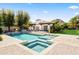 Inviting pool and spa with lush landscaping and a charming outdoor fireplace cabana, perfect for relaxation and entertaining at 5740 N Casa Blanca Dr, Paradise Valley, AZ 85253