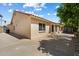 Exterior shot of house with a tile roof, large windows, and spacious backyard patio area at 63 W Los Arboles Dr, Tempe, AZ 85284