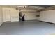 Spacious garage with epoxy flooring, ample storage cabinets, and utility connections at 63 W Los Arboles Dr, Tempe, AZ 85284