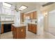 Bright eat-in kitchen featuring a center island, white appliances, and lots of cabinet space at 63 W Los Arboles Dr, Tempe, AZ 85284