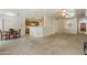 Bright living room with large windows, tile flooring near dining area, and open floor plan at 63 W Los Arboles Dr, Tempe, AZ 85284