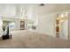 An expansive living room features bright windows and views into the kitchen and dining area at 63 W Los Arboles Dr, Tempe, AZ 85284